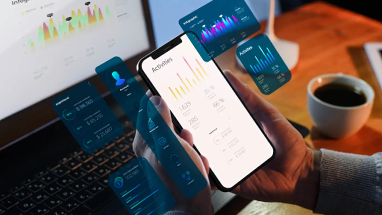 Person holding a smartphone displaying analytics dashboards, with floating data charts and metrics overlaid around a laptop and coffee cup.