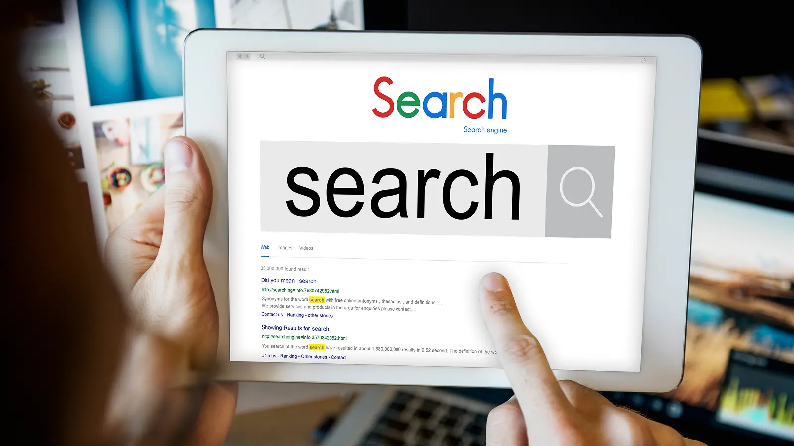 Person using a tablet to search online, highlighting the role of local SEO for car dealerships